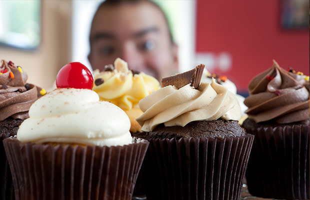 bigstock-Man-Looking-At-Cupcakes-38347156